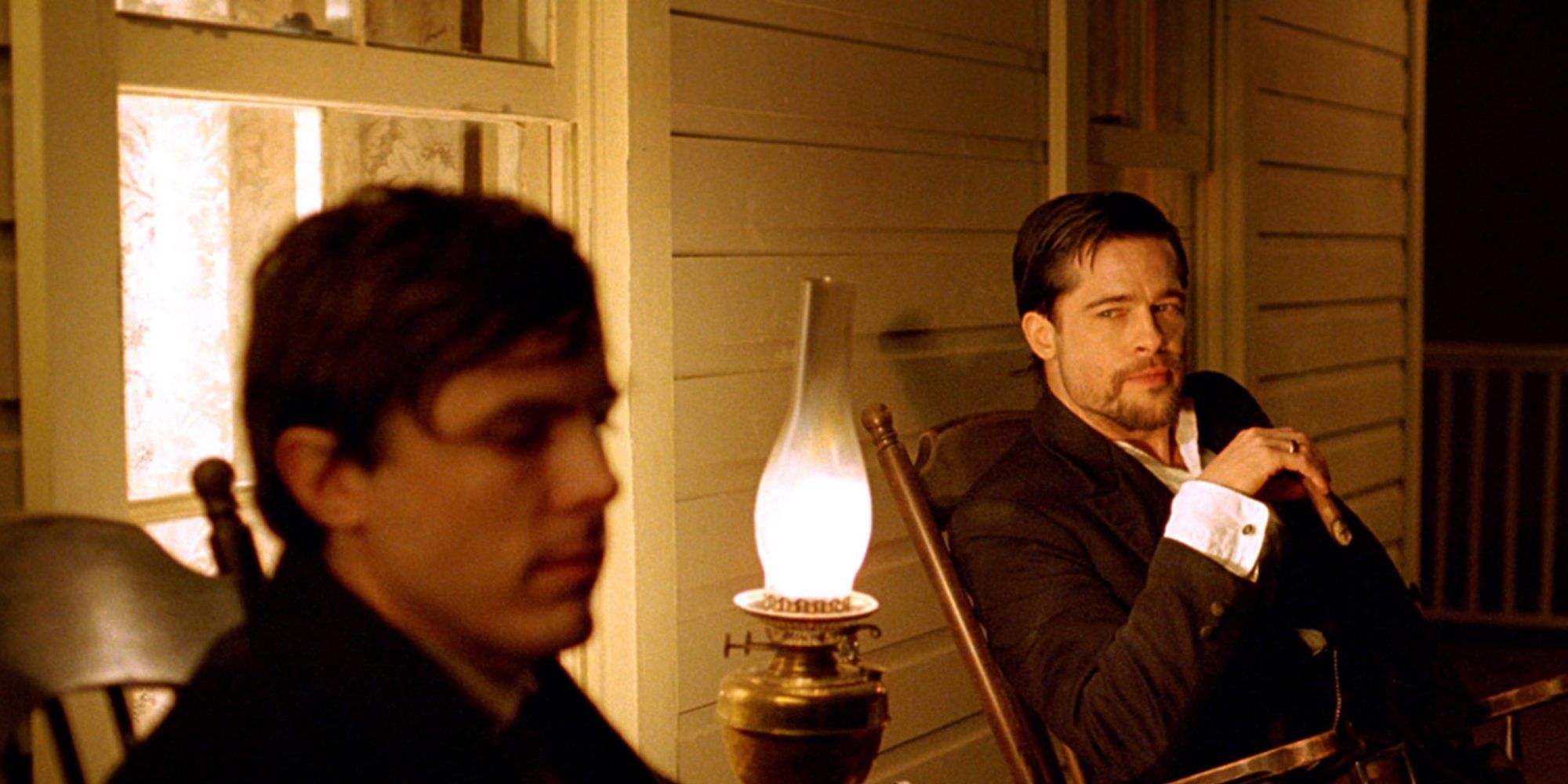 Casey Affleck and Brad Pitt sit together in The Assassination of Jesse James by the Cowardly Robert Ford.