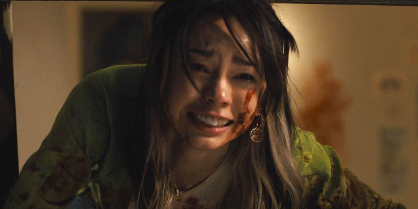 Devin Nekoda as Anika pleading from the window in Scream 6