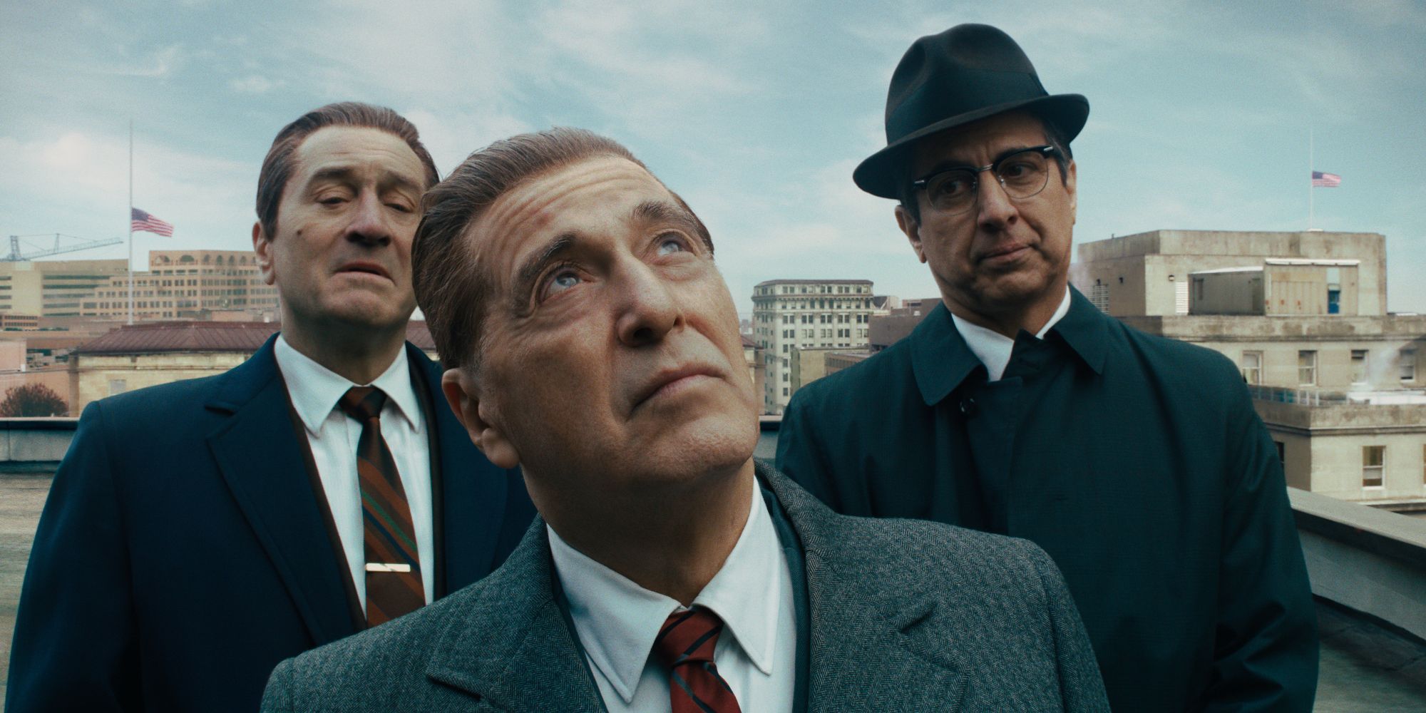 Jimmy Hoffa (Al Pacino) and two of his associates look at a sign in The Irishman.